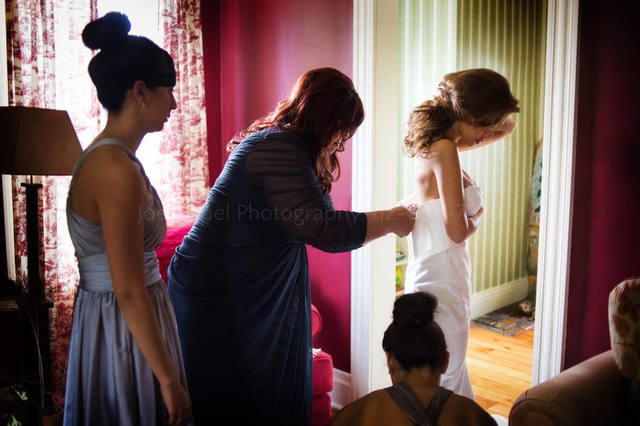 a bride's mother helps her get dressed before her wedding near Pittsburgh. Wedding Photography at Lingrow Farm.