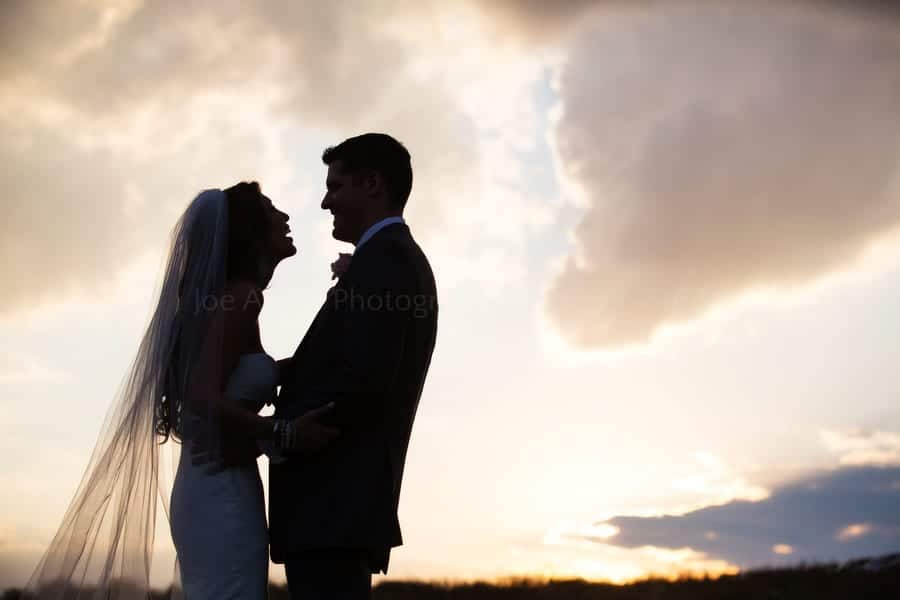 silhouette of a bride and groom at sunset in a field near Pittsburgh Pennsylvania. Wedding Photography at Lingrow Farm.