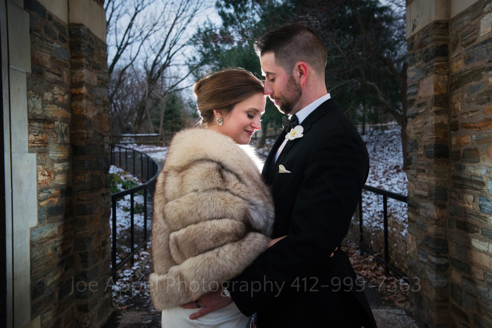 A beautiful rimlight surrounds a couple as they embrace in the twilight.