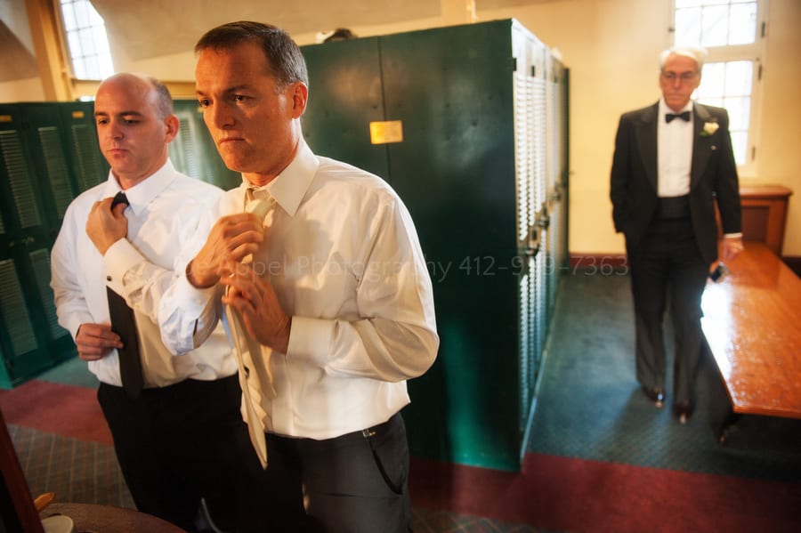 groom gets dressed in the men's locker room at Longue Vue Club