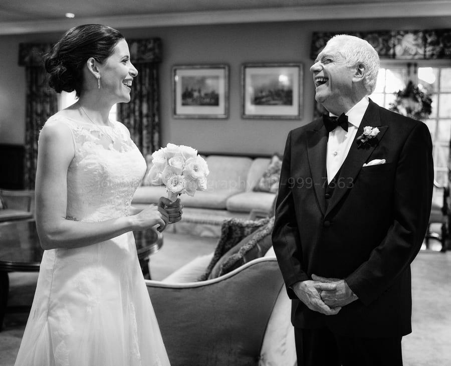 a bride and her father share a laugh just before her wedding ceremony