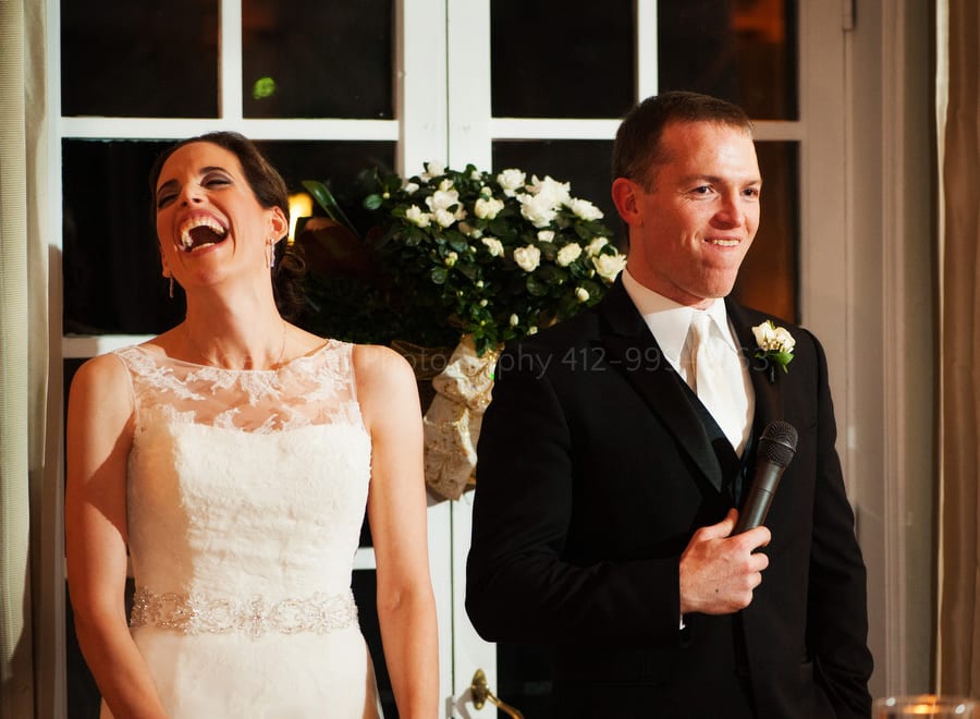 a bride and groom make a speech during their wedding
