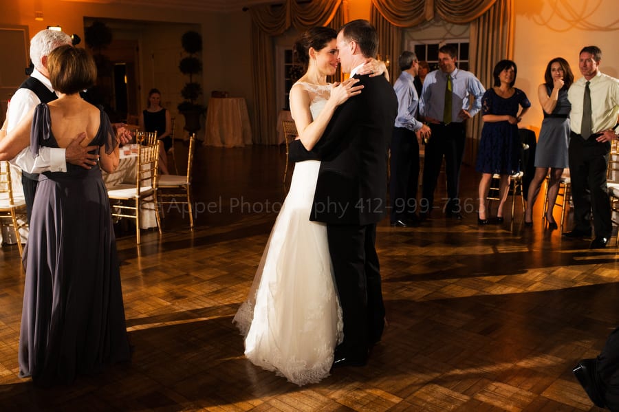 a bride and groom dance during their wedding