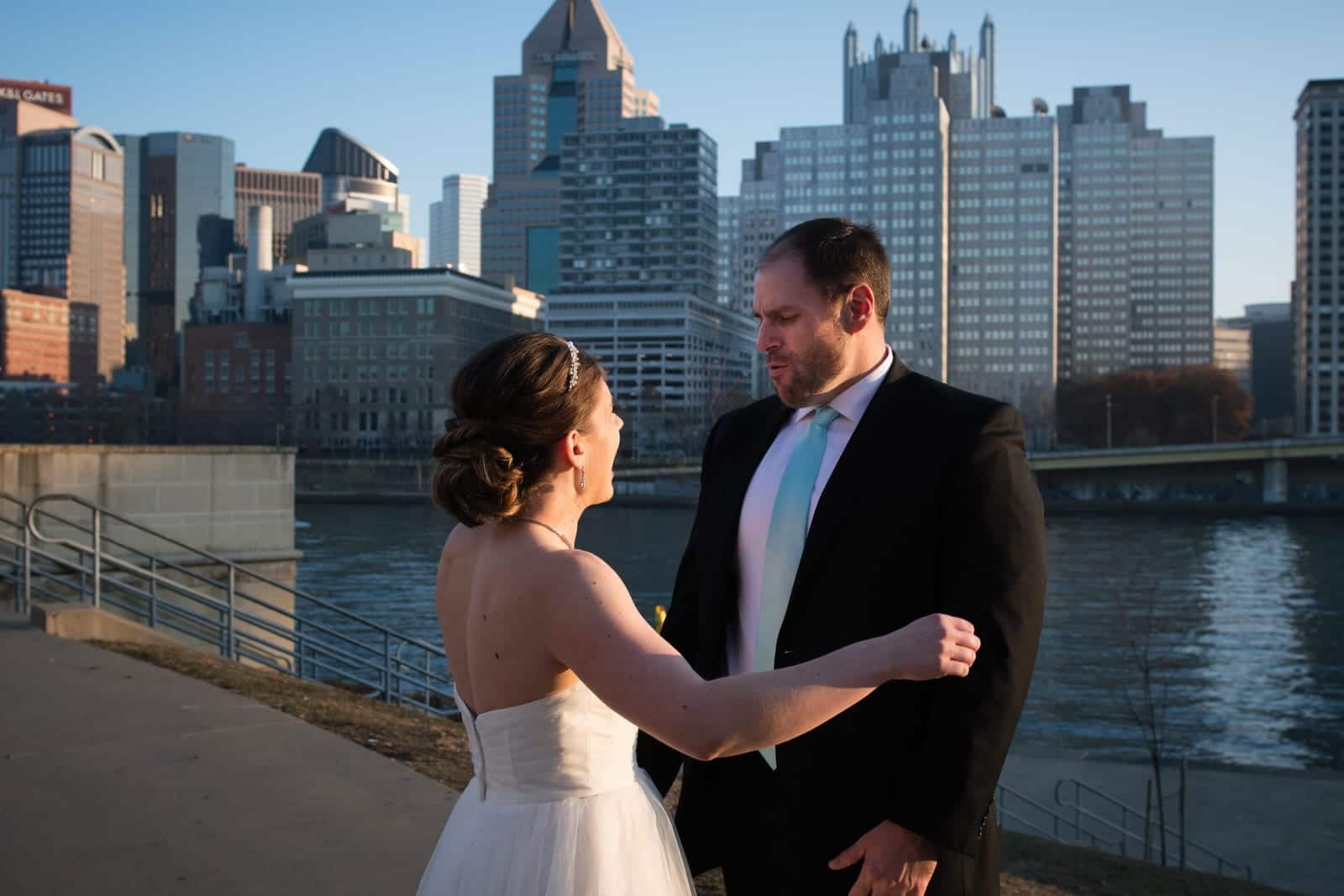 A groom whistles in approval as he turns to see his bride during their first look near PNC Park in Pittsburgh.