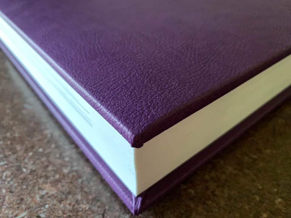 Detail photo of the purple leather on the cover of a beautiful custom wedding album.