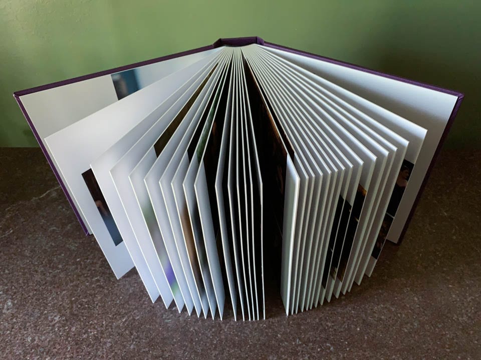 A 10x10 wedding album with the thick, archival pages spread out.