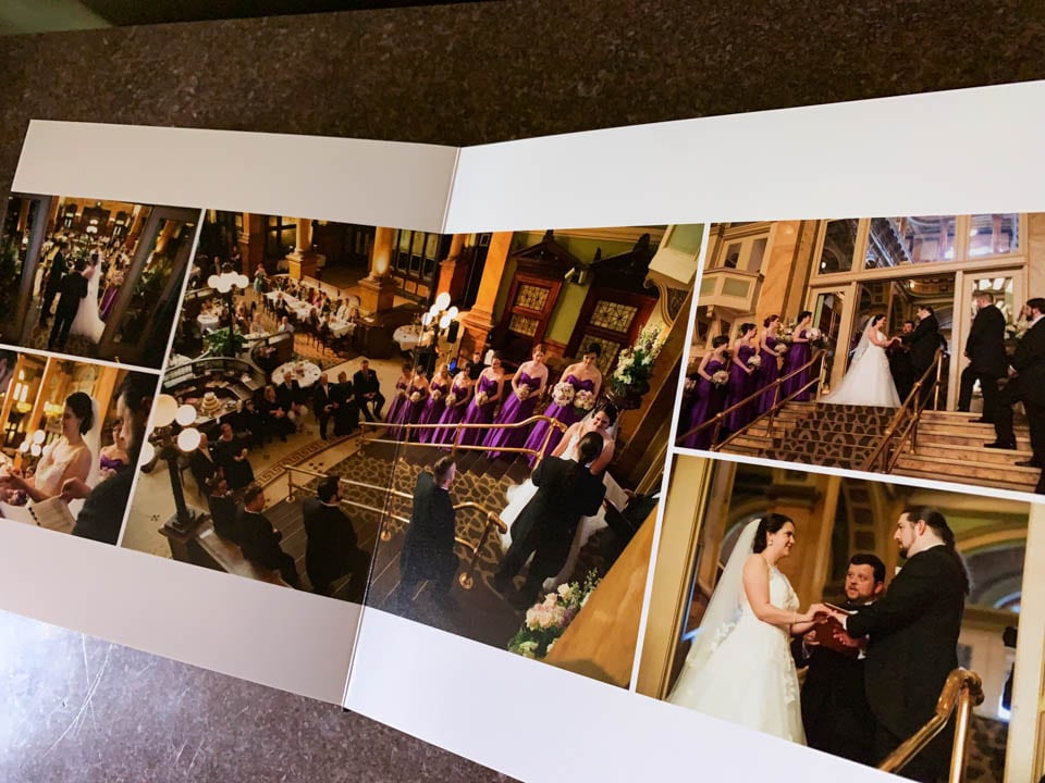 An open wedding album shows a 2-page spread of a wedding ceremony at the Grand Concourse in Pittsburgh.