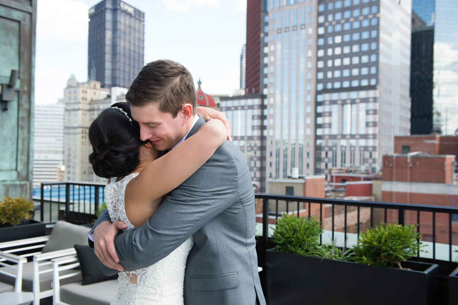 A bride and groom hug on the rooftop of the Renaissance Hotel Pittsburgh.