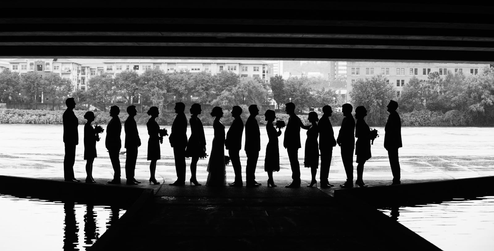A bridal party stands in silhouette at the bottom of the pedestrian walkway beneath the David L. Lawrence Convention Center in Pittsburgh.