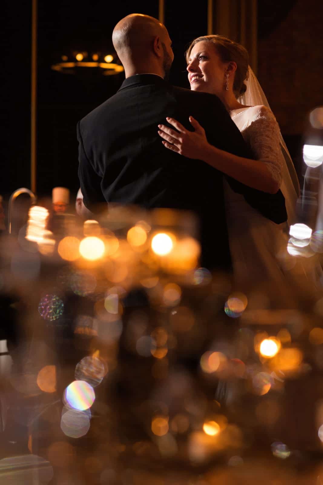 A bride and groom share a first dance at the Omni William Penn hotel by candlelight.