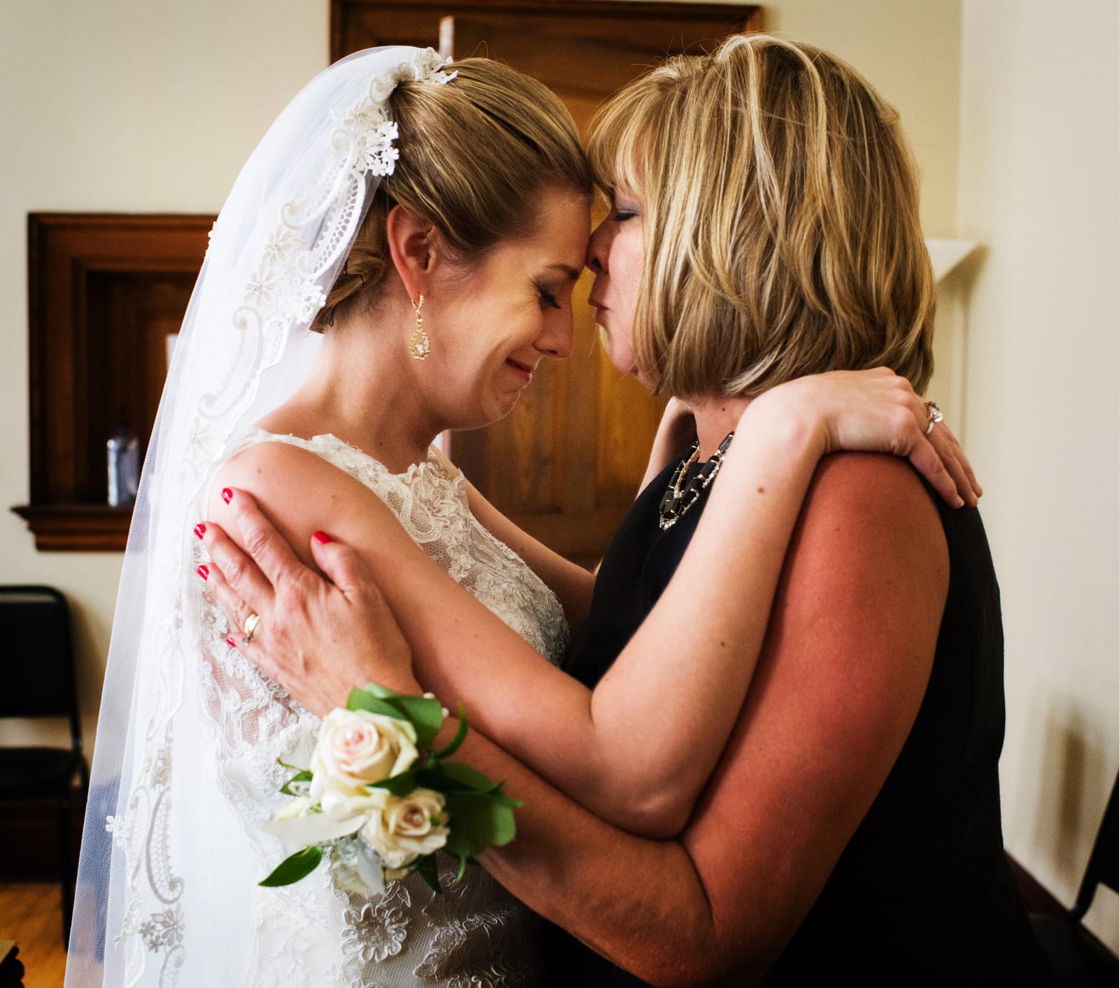 A bride cries as she hugs her mom before her wedding at the Wyndham Grand hotel in Pittsburgh.