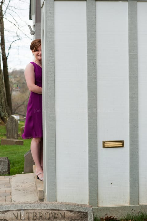 maid of honor peeks around the corner while waiting to enter the church before a wedding. Old St. Luke's Church Wedding