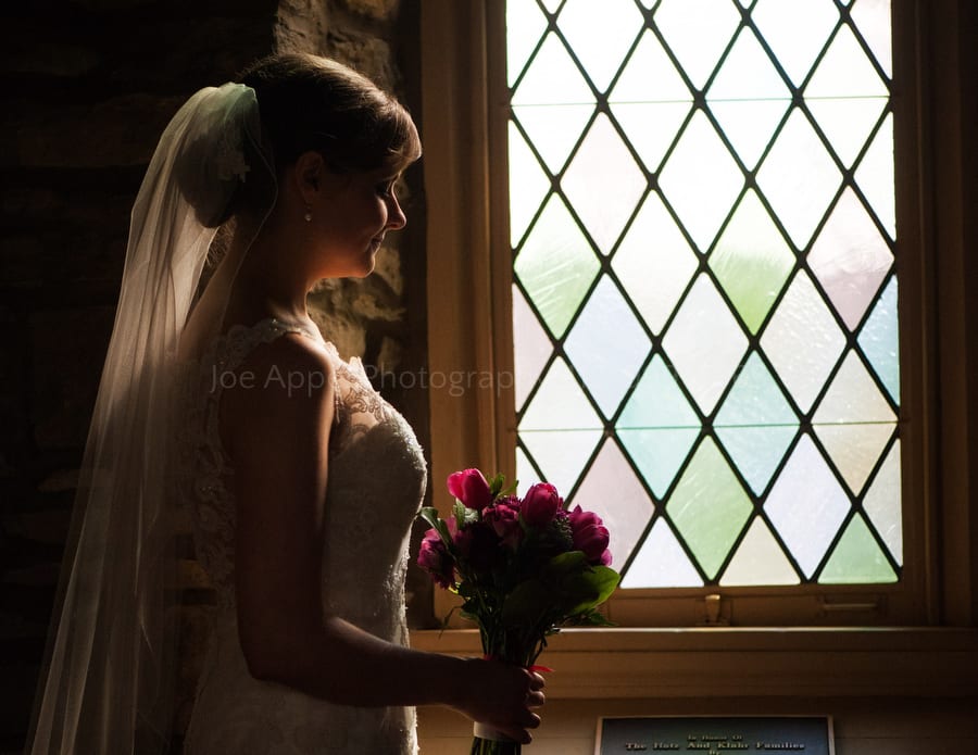 Bride looks out the window of Old St. Luke's Church in Pittsburgh. Old St. Luke's Church Wedding