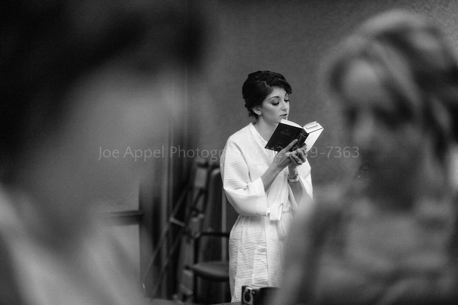 a bride reads from a prayer book before her wedding West Virginia Wedding Photography