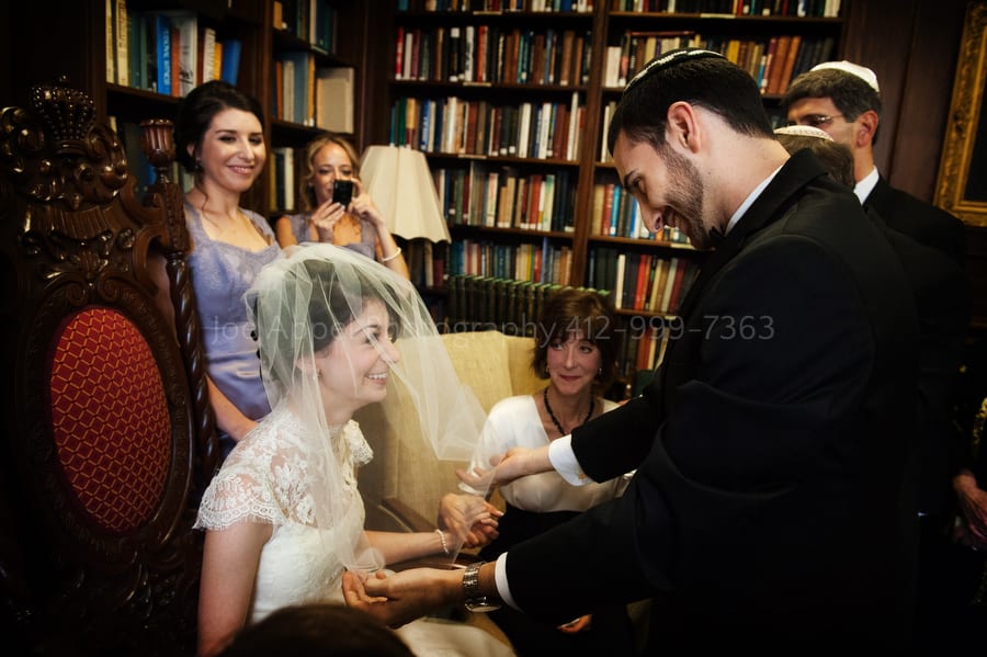 a groom pulls the veil over his bride's head during the badeken West Virginia Wedding Photography