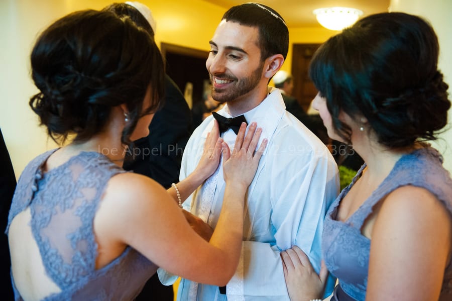 a groom's sisters show their love and affection for him before his wedding ceremony West Virginia Wedding Photography