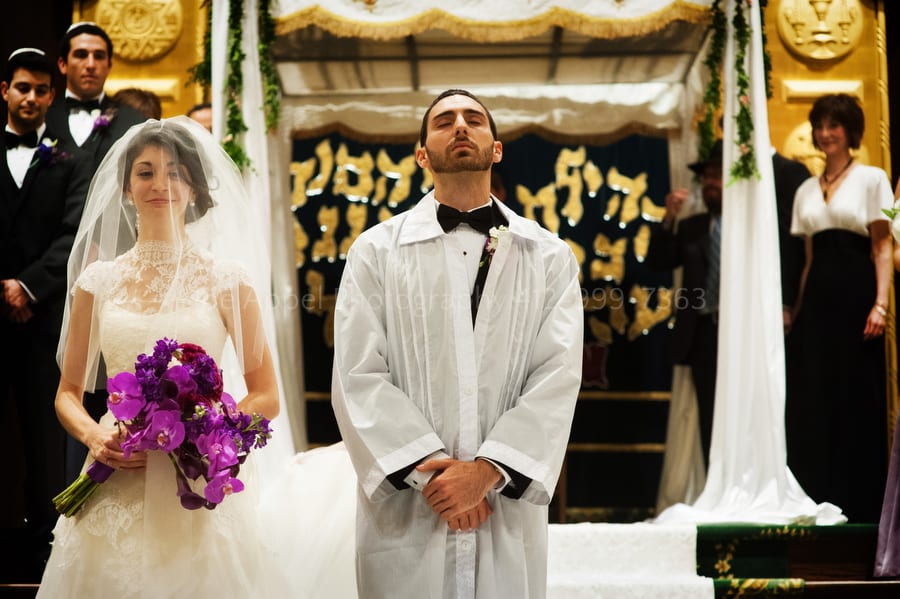 groom looks up to God as his bride circles him seven times West Virginia Wedding Photography