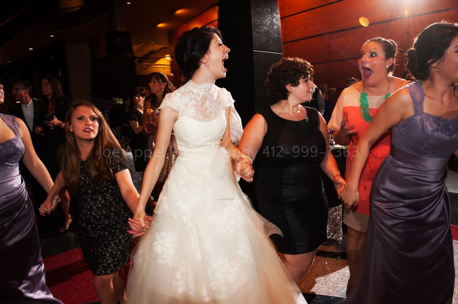bride dances in a circle with other women during the hora West Virginia Wedding Photography