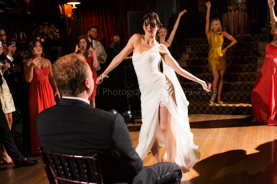 a bride approaches her groom while doing a burlesque dance