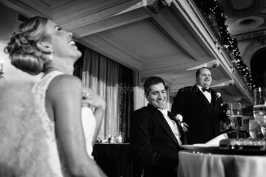bride laughs as her husband's best man roasts him during his toast William Penn Hotel Wedding Photography