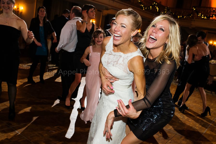 bride and her friend dance during the wedding reception William Penn Hotel Wedding Photography