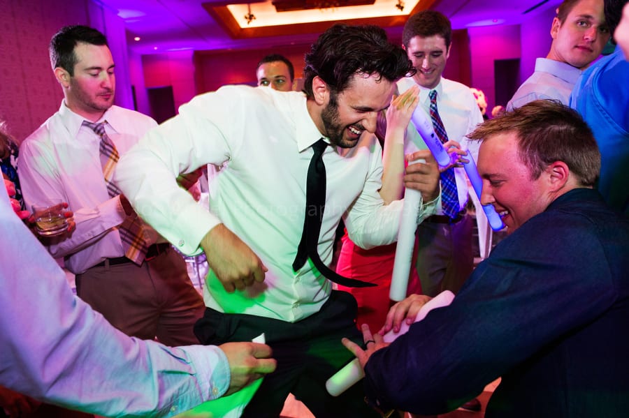 a group of guys play air guitar as they dance fairmont pittsburgh wedding