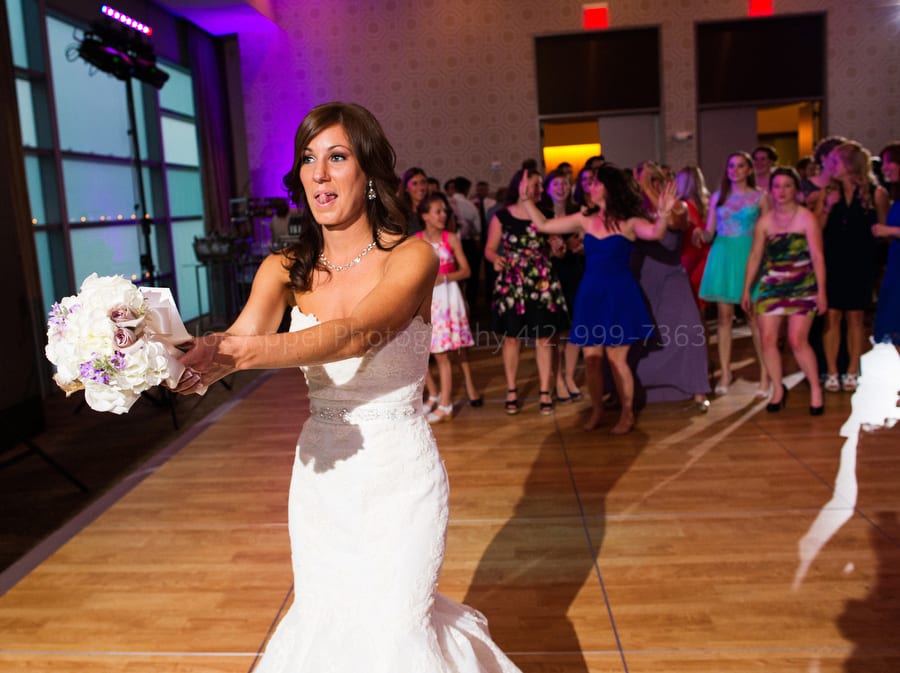 a bride gets ready to throw her bouquet to single women fairmont pittsburgh wedding