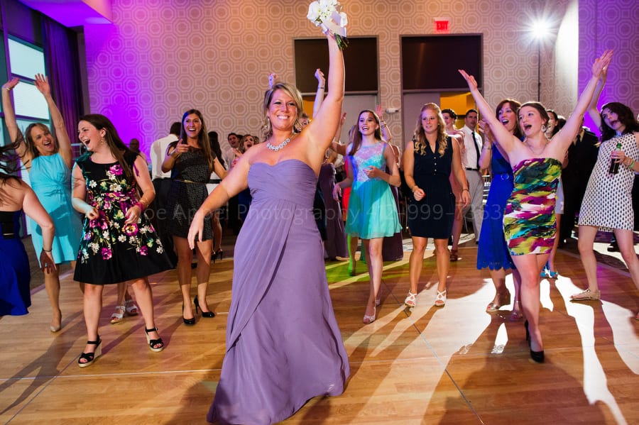 the maid of honor raises her hands in triumph after catching the bouquet fairmont pittsburgh wedding