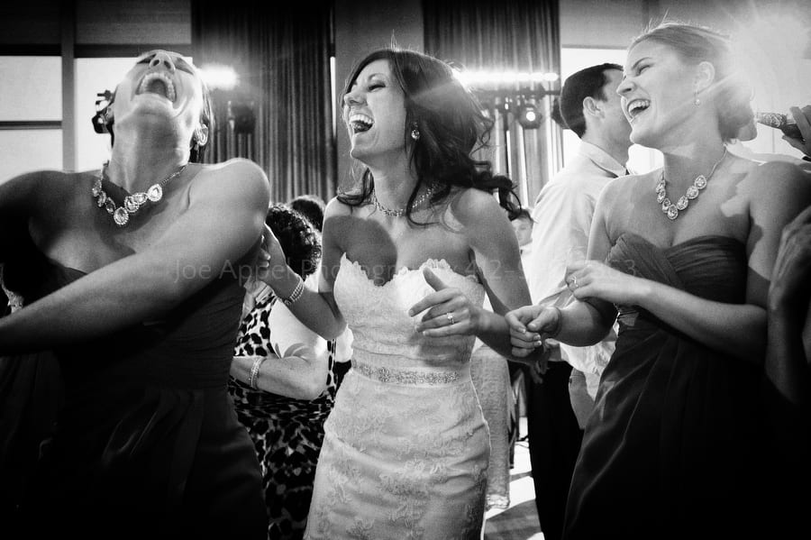 the bride and her bridesmaids laugh and dance together fairmont pittsburgh wedding