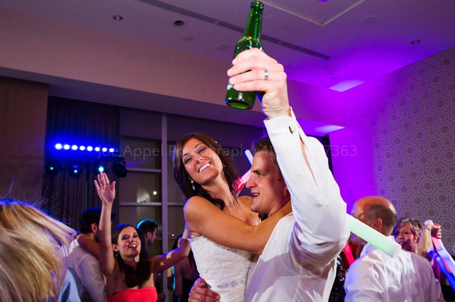 the groom lifts his bride and a beer during the last song of their wedding reception fairmont pittsburgh wedding