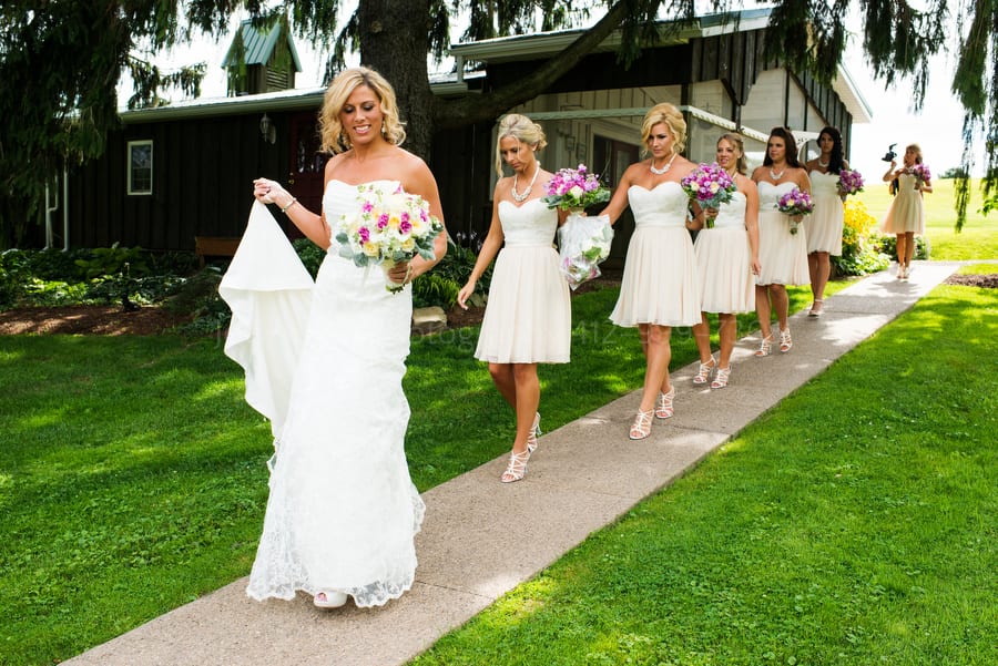 bride leads her bridesmaids to the wedding ceremony