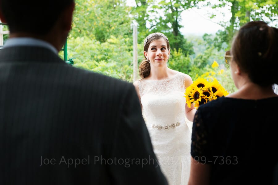 a bride smiles and rolls her eyes as she talks with her future in-laws outdoor wedding in pittsburgh