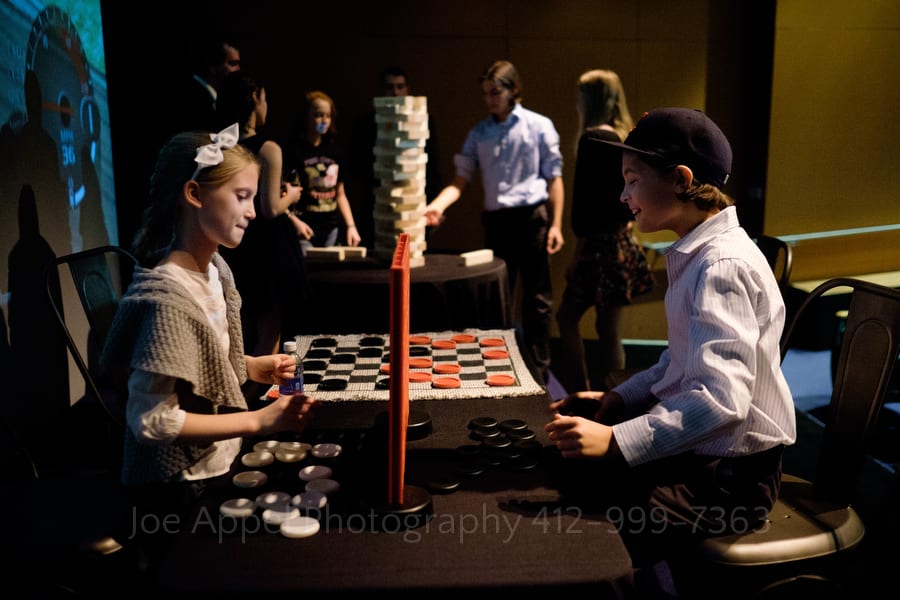 two children play connect four during a wedding reception andy warhol museum wedding