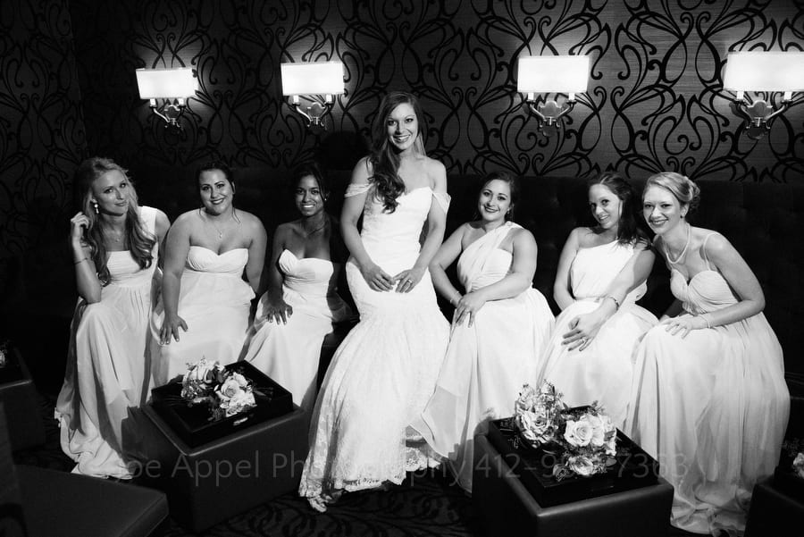Bride and her bridesmaids sit in the Speakeasy at the Omni William Penn in downtown Pittsburgh.
