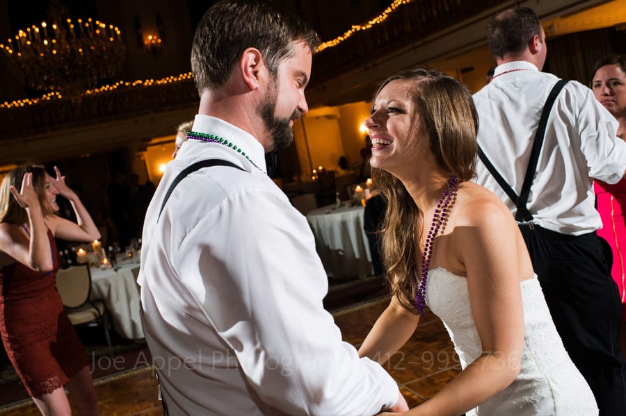 A bride and groom smile as they dance during their Omni William Penn wedding in downtown Pittsburgh.