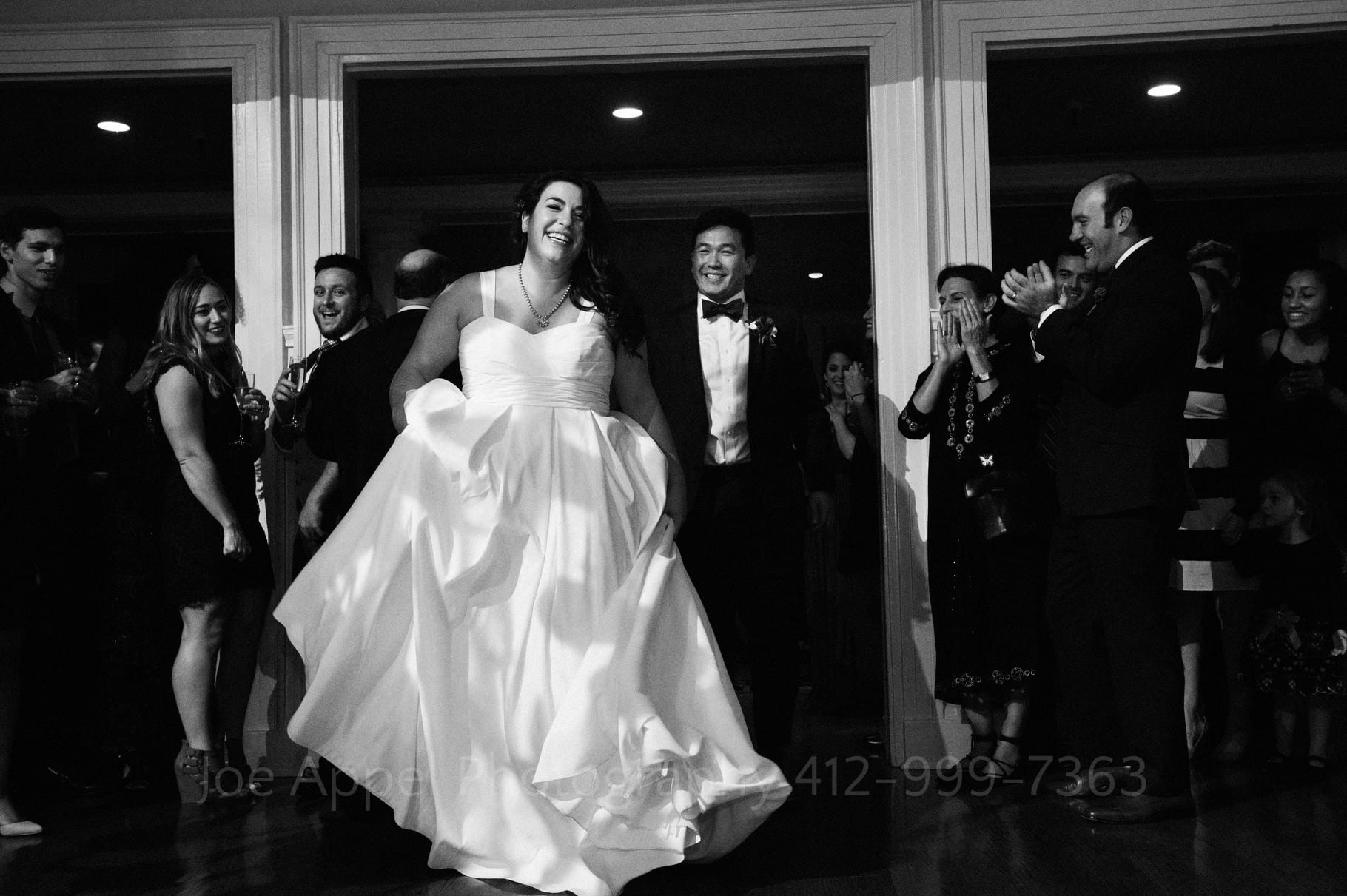 Bride and groom smile as they enter their reception during their Pittsburgh Golf Club wedding