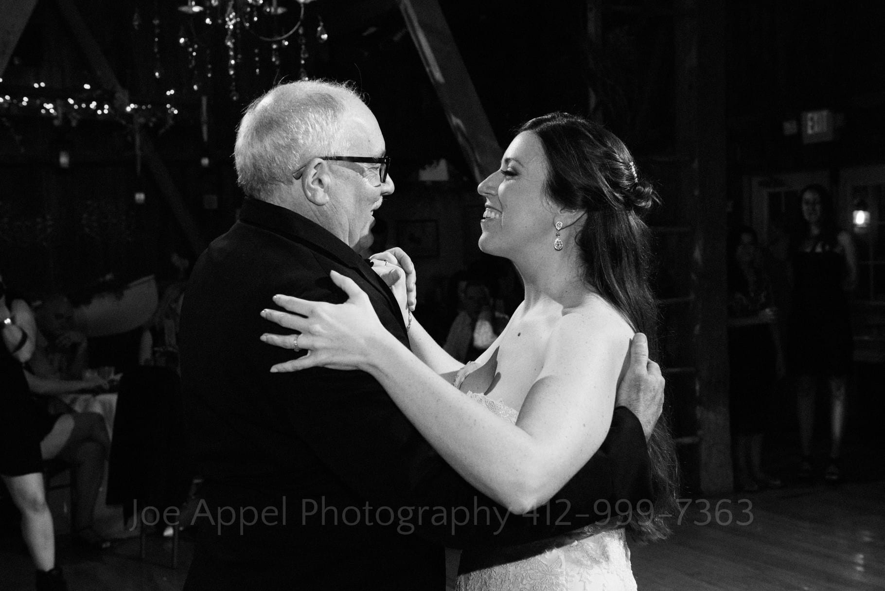 a bride dances with her father during her Chanteclaire Farm Wedding.