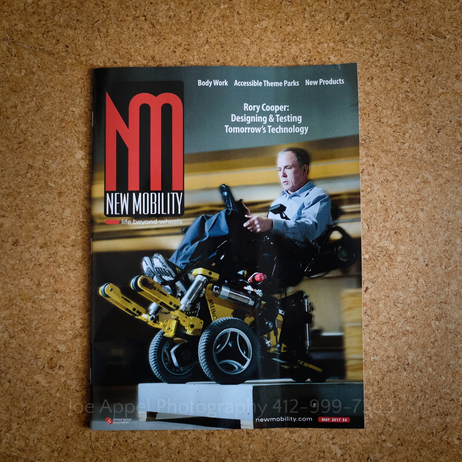magazine cover from an editorial photo shoot in pittsburgh by Pittsburgh Editorial Photographers Joe Appel Photography. the cover features a man on a yellow all-terrain motorized wheelchair riding the chair off of a step.