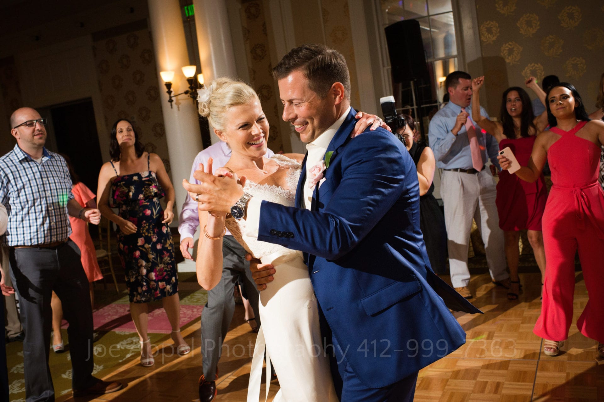Bride and groom smile as they spin and dance on the dance floor during their Omni Bedford Springs Wedding.