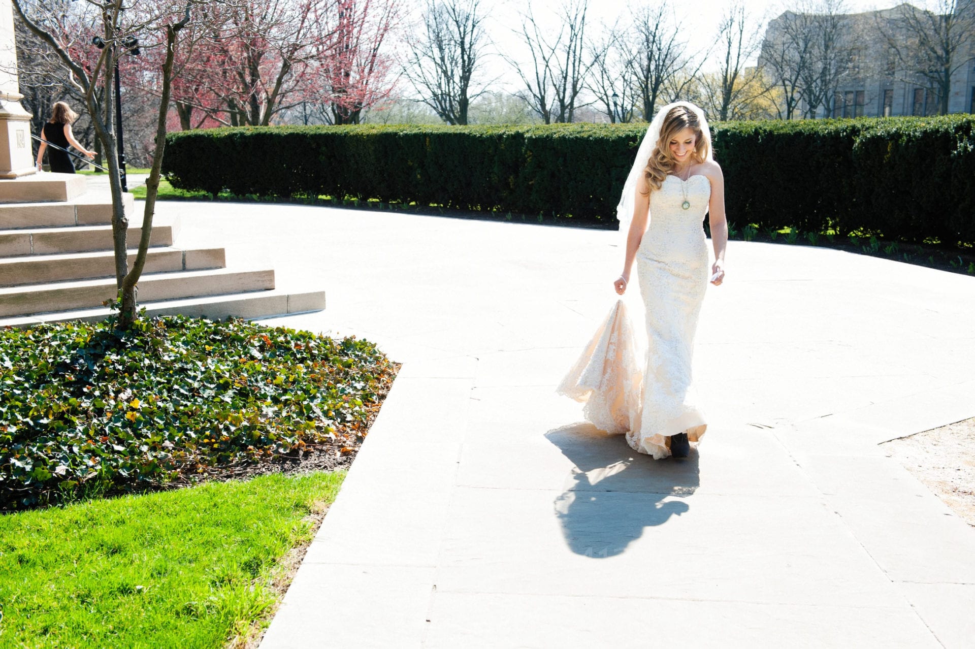 a beautiful blonde bride walks along the path outside of heinz chapel