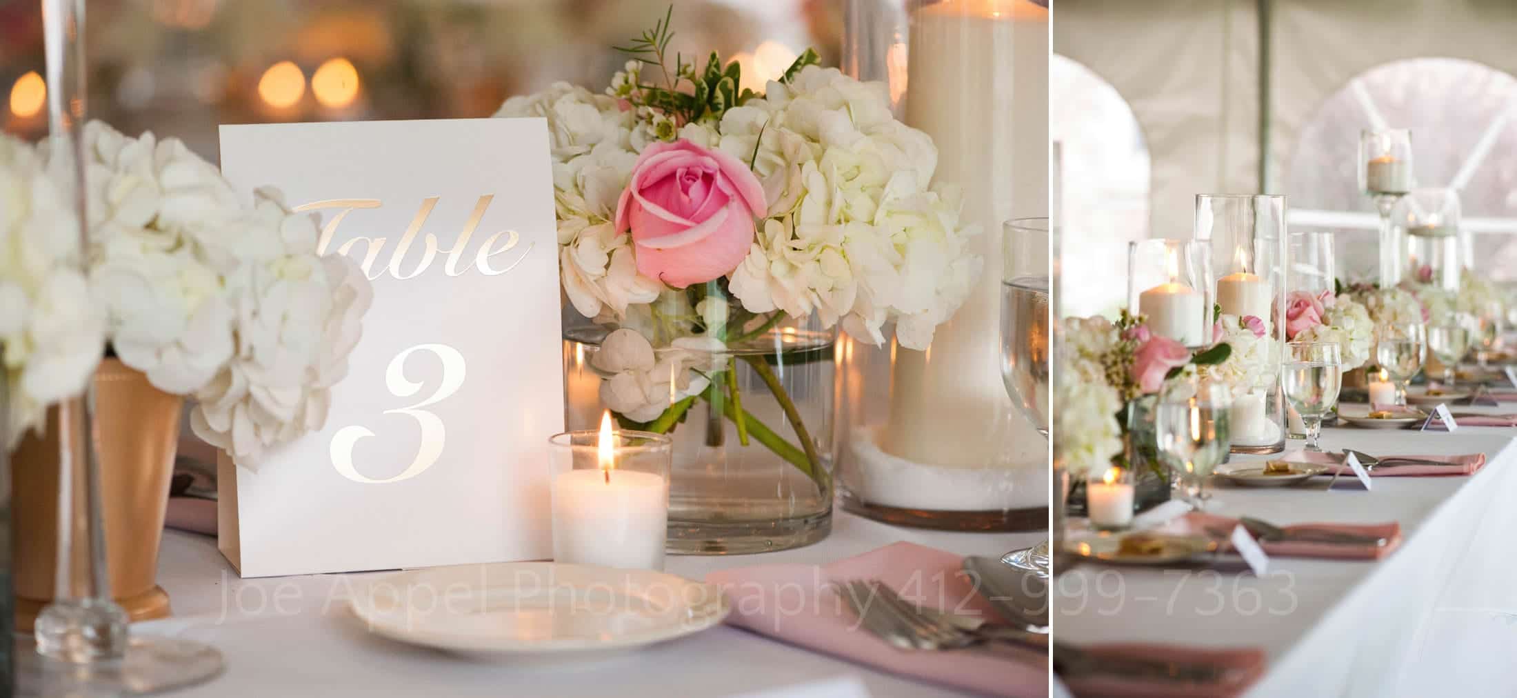 pink rose and geranium centerpieces on a long tables inside of a tent.