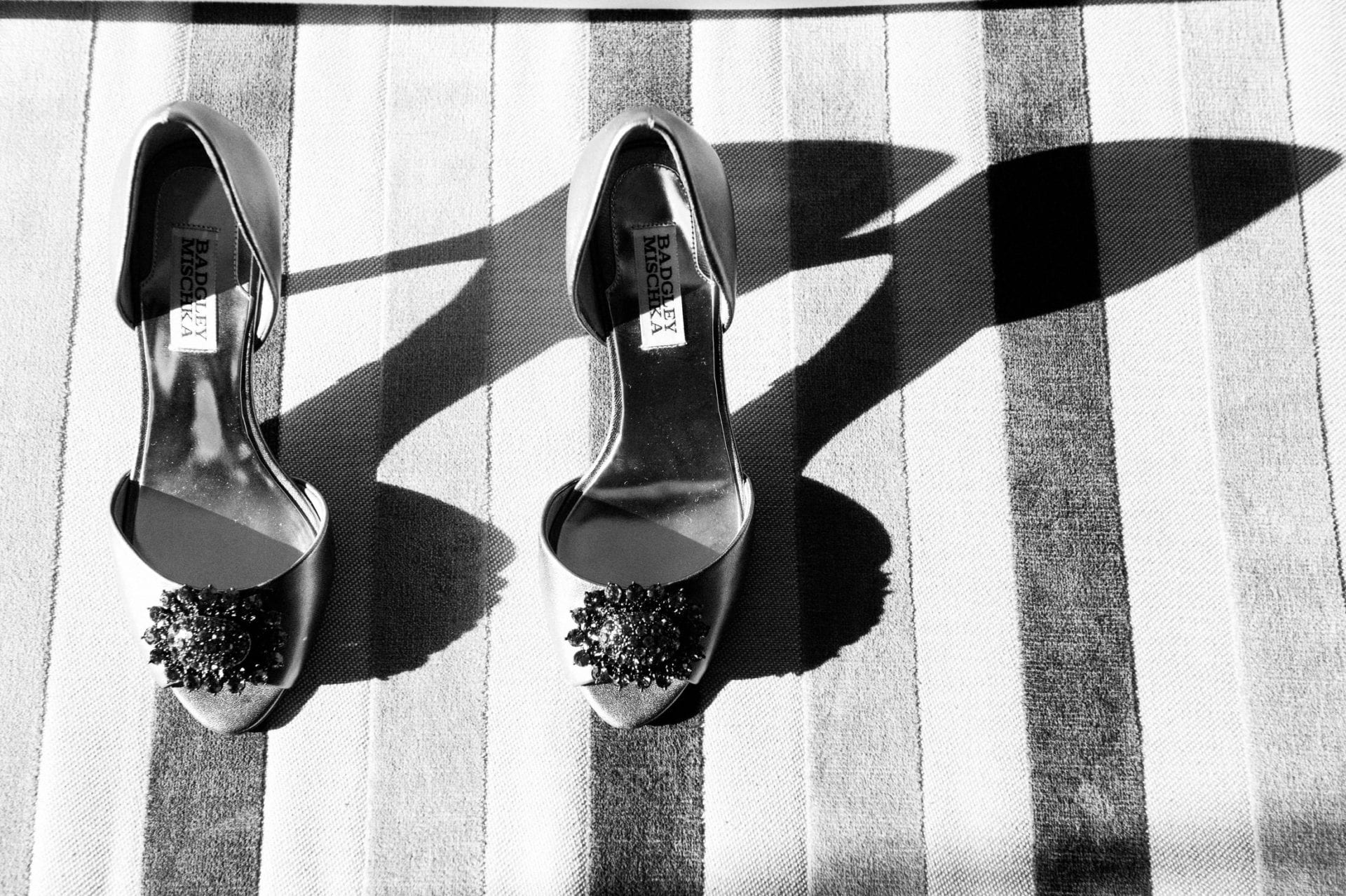 high heels cast shadows on a striped cushion Fairmont Hotel Pittsburgh Weddings.