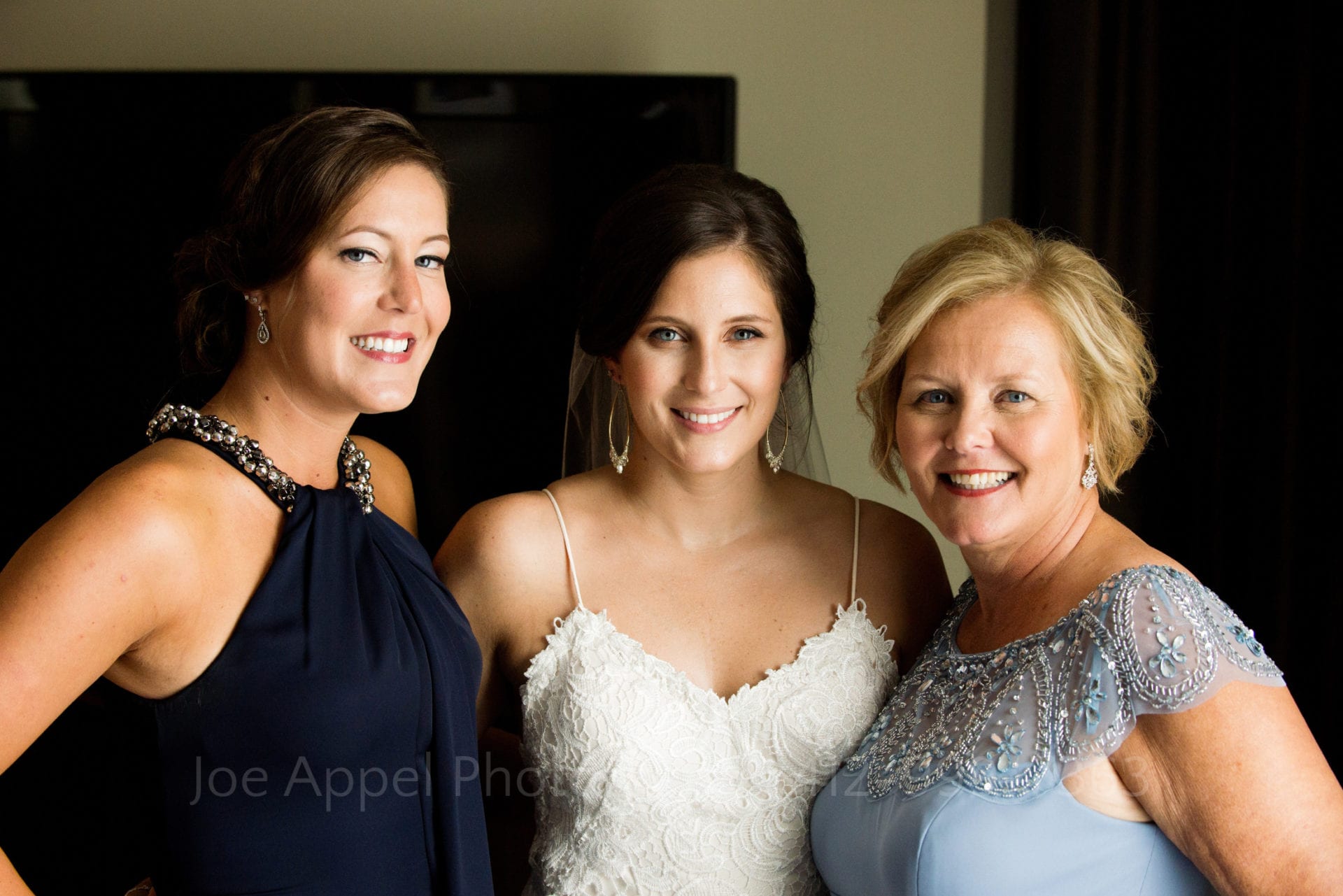 A bride stands with her sister and her mother Fairmont Hotel Pittsburgh Weddings.