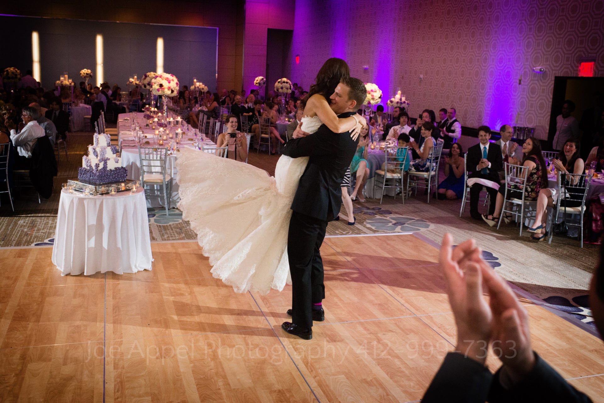 A groom picks up his bride on the dance floor Fairmont Hotel Pittsburgh Weddings.