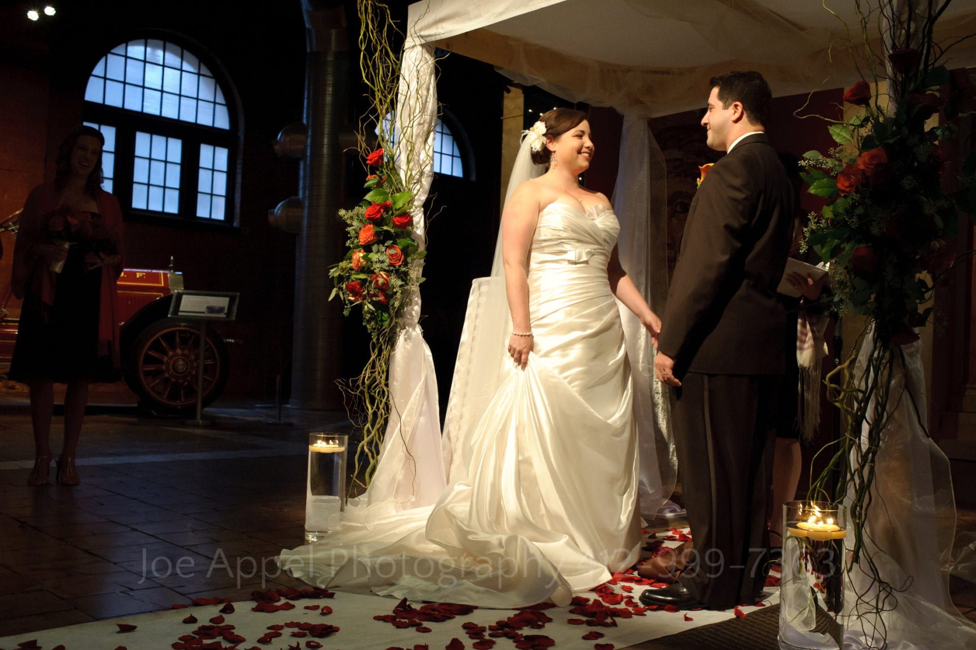 bride and groom face each other during their ceremony in the Great Hall at the Heinz History Center