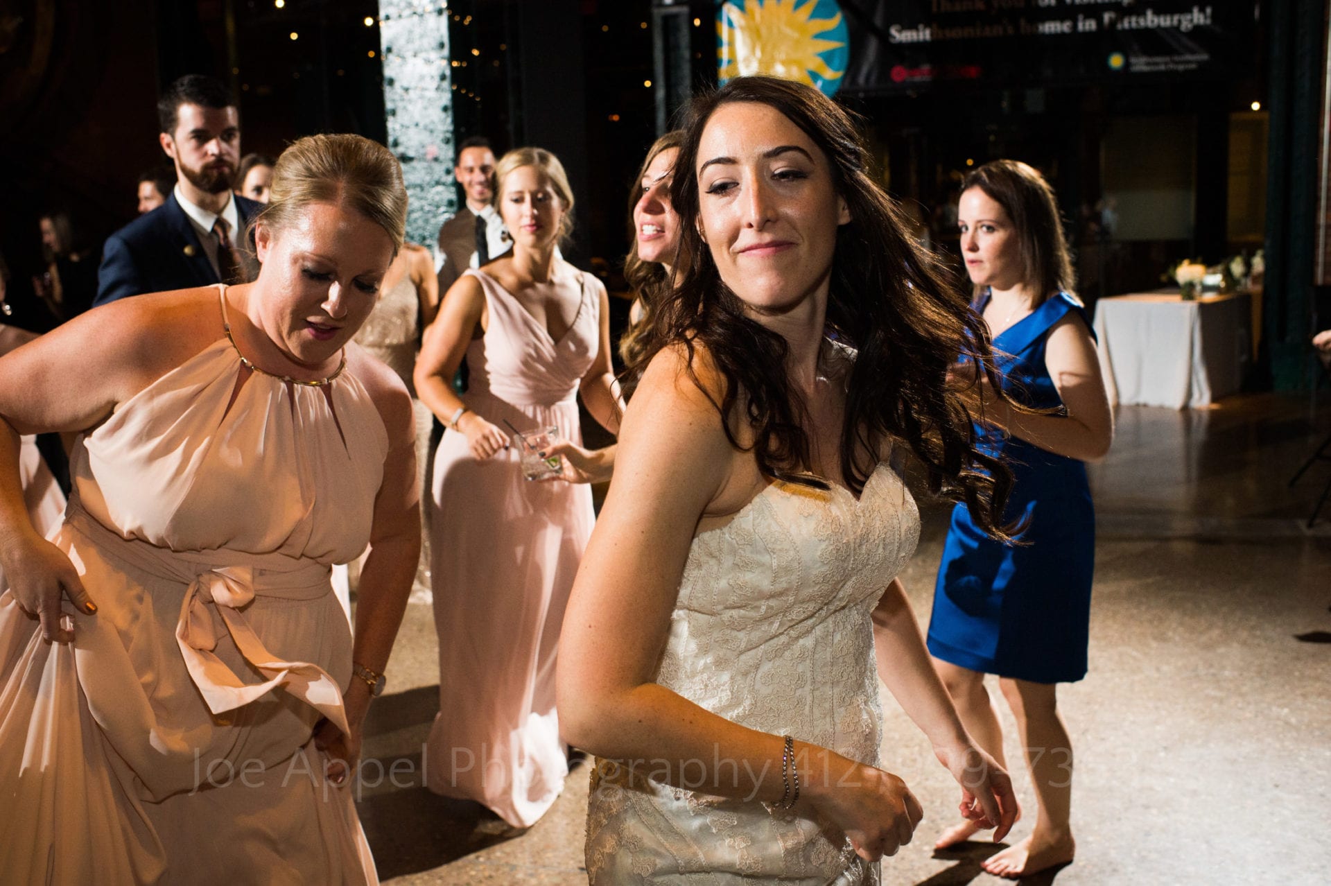 A bride dances with her bridesmaids in the Great Hall at the Heinz History Center.