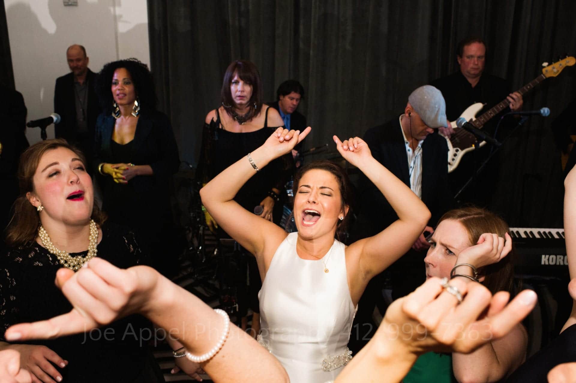 a bride sings and dances with her guests
