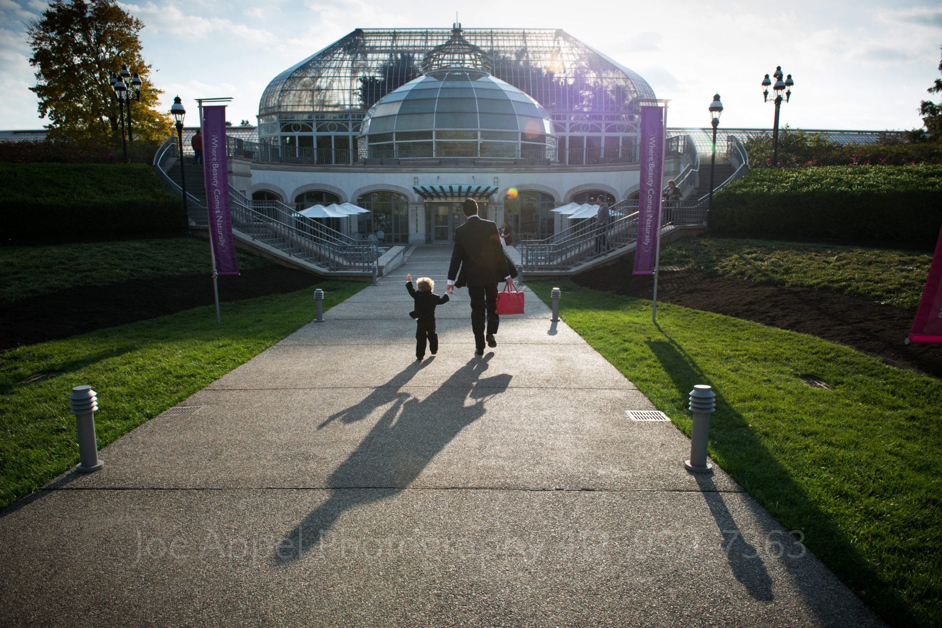 a man and boy wearing suits walk to the entrance of phipp's conservatory Phipps Conservatory Weddings