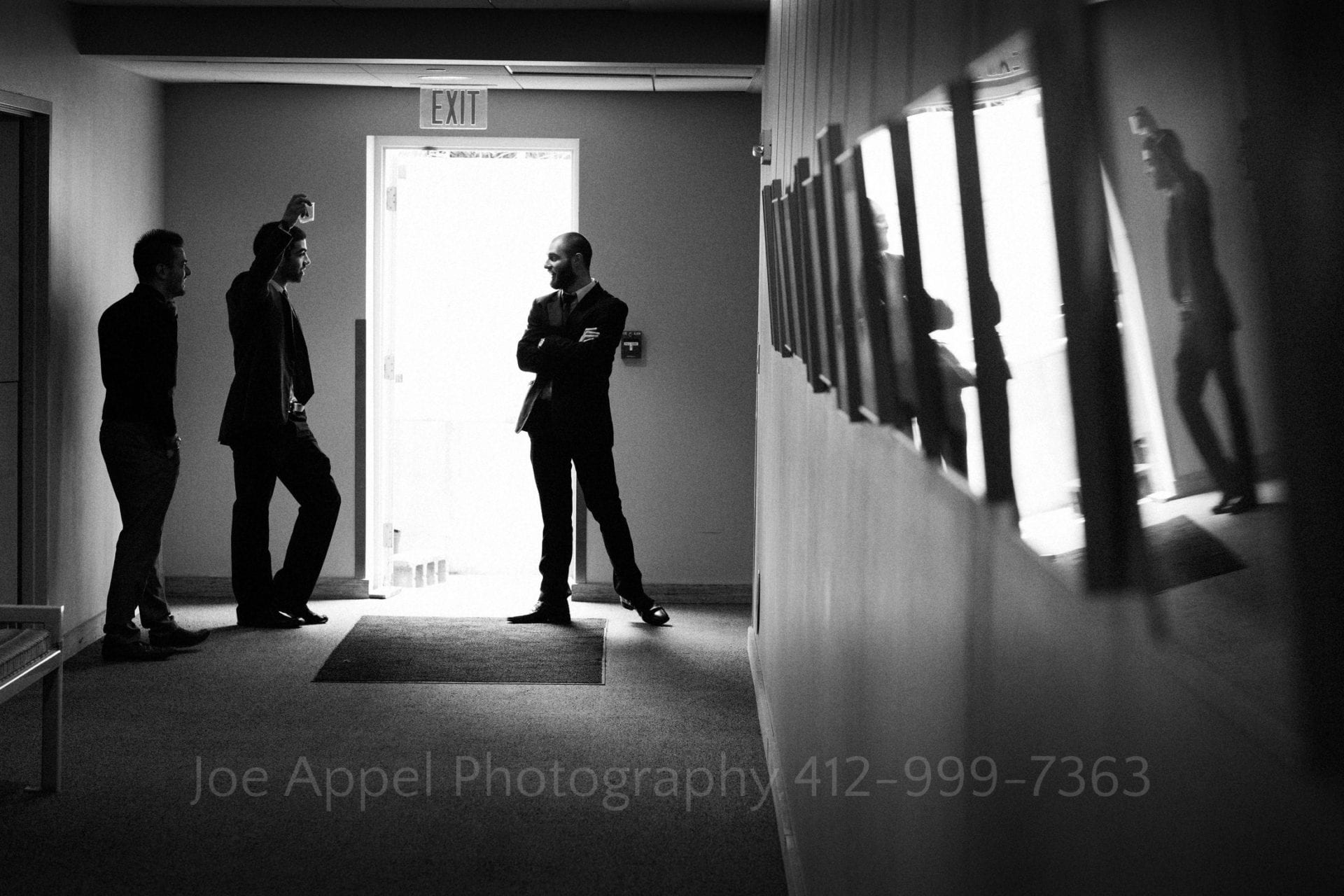 a groom and his groomsmen talk by the exit Phipps Conservatory Weddings
