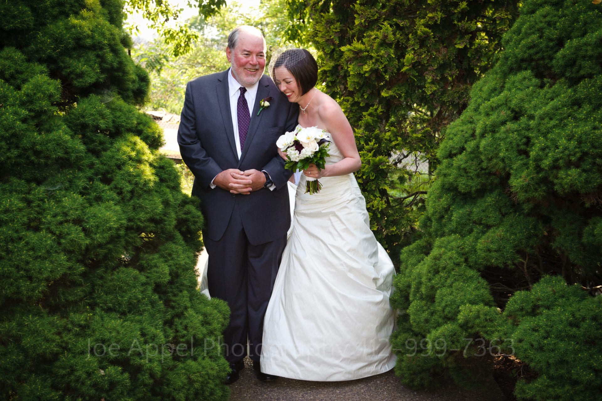 a bride and her father laugh near green trees Phipps Conservatory Weddings